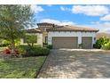 House exterior with two-car garage and landscaping at 13126 Indigo Way, Bradenton, FL 34211