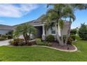 Well-maintained home with lush landscaping and healthy palm trees in the front yard at 13789 Old Creek Ct, Parrish, FL 34219