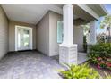 Inviting front porch featuring stone pavers and a decorative front door at 13789 Old Creek Ct, Parrish, FL 34219