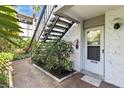 Condo entrance with stairs and tropical plants at 1555 Tarpon Center Dr # 135, Venice, FL 34285
