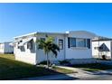Immaculately maintained white mobile home with palm tree at 3334 Overcup Oak Ter, Sarasota, FL 34237