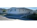 Neat white mobile home with covered carport and mailbox at 3334 Overcup Oak Ter, Sarasota, FL 34237