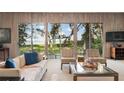 Bright living room with water views, comfortable seating, and a stylish glass coffee table at 3350 Old Oak Dr, Sarasota, FL 34239