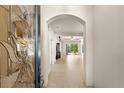 Bright entryway with an arched hallway and glass door at 3614 Summerwind Cir, Bradenton, FL 34209