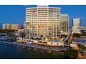 Modern high-rise building overlooking the water at dusk at 401 Quay Commons # 901, Sarasota, FL 34236