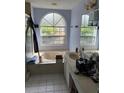 Main bathroom with a bathtub, double vanity, and large window at 4760 Camphor Ave, Sarasota, FL 34231