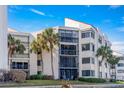 Exterior view of a condo building with palm trees and balconies at 5633 Puerta Del Sol S Blvd # 307, St Petersburg, FL 33715