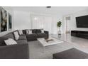 Spacious living room with stylish sectional sofa and marble coffee table at 6015 Union Pl, Bradenton, FL 34207