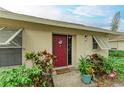 Front door entry with red door and potted plants at 718 N Jefferson Ave # 718, Sarasota, FL 34237
