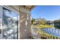 White wicker chair on balcony with pond view at 850 S Tamiami Trl # 731, Sarasota, FL 34236