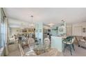 Bright dining area with glass table and wicker chairs at 850 S Tamiami Trl # 731, Sarasota, FL 34236