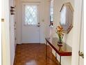 Entryway with wood-look tile and entry table at 1211 Capri Isles Blvd # 72, Venice, FL 34292