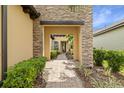 Elegant entryway with a stone walkway leading to a charming front door at 224 Corelli Dr, Nokomis, FL 34275