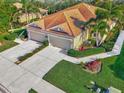 An aerial view showcasing the home's roof, two-car garage, and surrounding community at 2520 Terracina Dr, Venice, FL 34292