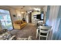 Open-concept living area with a sofa, dining table, and view of the kitchen at 3333 26Th E Ave # 1107, Bradenton, FL 34208