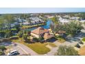 Stunning aerial view of a home nestled by a serene lake with lush greenery and neighboring properties at 3468 51St Avenue W Dr, Bradenton, FL 34210