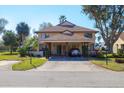 Inviting home showcasing a covered carport, a blue front door, and meticulously maintained landscaping at 3468 51St Avenue W Dr, Bradenton, FL 34210