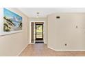 Bright foyer with tile flooring and access to other rooms at 3988 Abbotsford St, North Port, FL 34287