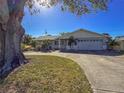 Charming single-story home with lush landscaping, a large driveway, and a two-car garage at 4001 17Th W Ave, Bradenton, FL 34205