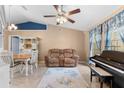 Open living room and dining area with vaulted ceilings and ample natural light at 5105 Bannock Cir, North Port, FL 34288