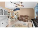 Combined living and dining area with white hutch, loveseat, and piano at 5105 Bannock Cir, North Port, FL 34288