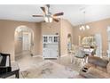 Living room featuring a loveseat, piano, arched entryways, and dining area at 5105 Bannock Cir, North Port, FL 34288