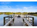 Scenic view of the community dock on the water, complete with benches and a flagpole at 5611 Key West Pl # 5611, Bradenton, FL 34203