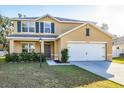 Front exterior of a two-story home with a driveway, attached garage, and landscaping at 7005 57Th E Ter, Palmetto, FL 34221