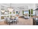 Bright dining room features a large chandelier and seating for six at 8020 Moonbeam Ave, Sarasota, FL 34241