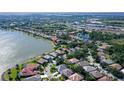Aerial view showcasing a house near a lake in a community at 8334 Sailing Loop, Lakewood Ranch, FL 34202