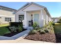 Front exterior of a charming house with a welcoming walkway and landscaping at 12583 Sagewood Dr, Venice, FL 34293