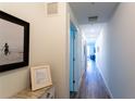 Bright hallway with wood-style flooring leading to the living area at 1709 N Tamiami Trl # 214, Sarasota, FL 34234