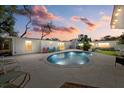 Inviting backyard featuring a sparkling pool, large patio area, and lush landscaping, perfect for outdoor entertaining at 2069 Bougainvillea St, Sarasota, FL 34239