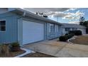 Concrete driveway and attached garage of a single-story house at 214 Genet Ct, Sun City Center, FL 33573