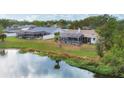 An aerial view showcasing a house's backyard oasis, complete with a pool and serene lake view at 2215 39Th W St, Bradenton, FL 34205
