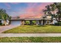 Brick, single-story home with attached garage and well-manicured lawn at 2215 39Th W St, Bradenton, FL 34205