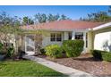 Front view of a house with a screened entrance and manicured shrubs at 3424 Brookridge Ln, Parrish, FL 34219