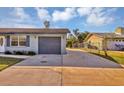 Long concrete driveway leading to attached one-car garage at 4064 Velarde Ln, Sarasota, FL 34235