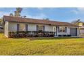Inviting single-story home with a lush green lawn and neat landscaping at 4064 Velarde Ln, Sarasota, FL 34235