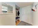Bright condo entryway with built-in bench and mirror at 4550 Pinebrook Cir # 304, Bradenton, FL 34209