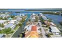 Aerial view of a neighborhood with homes on canals near the bay at 579 Bayview Dr, Longboat Key, FL 34228