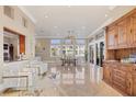 Spacious living area showcasing travertine flooring, soaring ceilings, and abundant natural light at 591 Putting Green Ln, Longboat Key, FL 34228