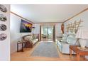Living room features a large TV, comfy seating, and wood floors at 5927 17Th W St # A21, Bradenton, FL 34207
