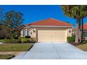 Front exterior of home with tile roof, double garage, and neat landscaping at 616 Misty Pond Ct, Bradenton, FL 34212