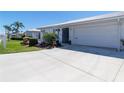 A well-maintained front lawn and driveway lead to an attached two-car garage at 6913 8Th W Ave, Bradenton, FL 34209