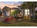 Beautiful stone accents highlight this single-Gathering home with a brick driveway and manicured landscaping at 7130 Whittlebury Trl, Bradenton, FL 34202