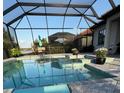 Inviting screened-in pool area with a relaxing lounge space, outdoor dining set, and serene backyard view at 7130 Whittlebury Trl, Bradenton, FL 34202