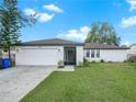 Charming one-story house featuring a white brick exterior, brown roof, and a landscaped front yard at 722 Sailfish Dr, Brandon, FL 33511