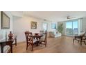 Bright condo dining area with hardwood floors and round table at 800 N Tamiami Trl # 403, Sarasota, FL 34236