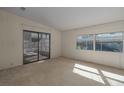 Bright living room with sliding glass doors leading to enclosed porch at 8411 Regal Way, Palmetto, FL 34221